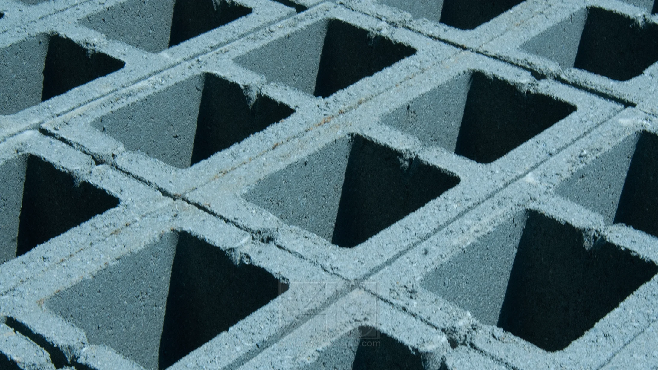 Abstract photography of a grid of cement blocks taken in Brussels, Belgium. by Annamaria DiSanto