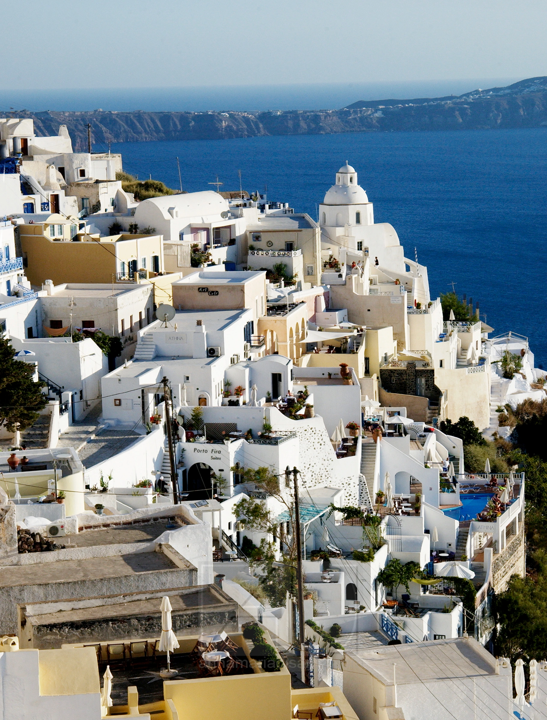 Photograph depicts the whitewashed buildings and caldera views of Fira, the capital city of Santorini, Greece by Annamaria DiSanto
