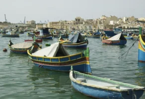 HARBOR OF MARSAXLOKK, MALTA Traditional Maltese luzzu fishing boats in the harbor of Marsaxlokk, Malta, photographed by Annamaria DiSanto